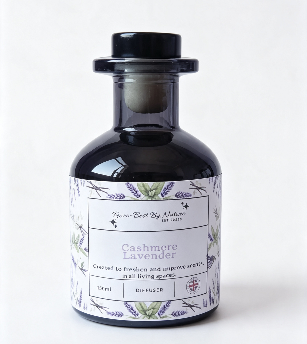 A dark glass diffuser bottle with a black stopper and a white label featuring lavender illustrations and the text 'Rowe-best By Nature' and 'Cashmere Lavender'.