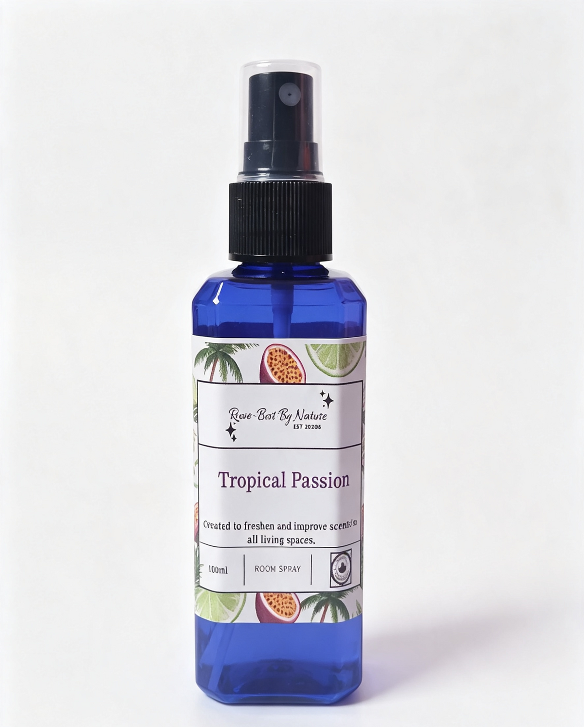 A 100ml room spray bottle of 'Tropical Passion' by Rowe-best By Nature, featuring a blue bottle, black spray nozzle, and a white label decorated with tropical fruit illustrations.